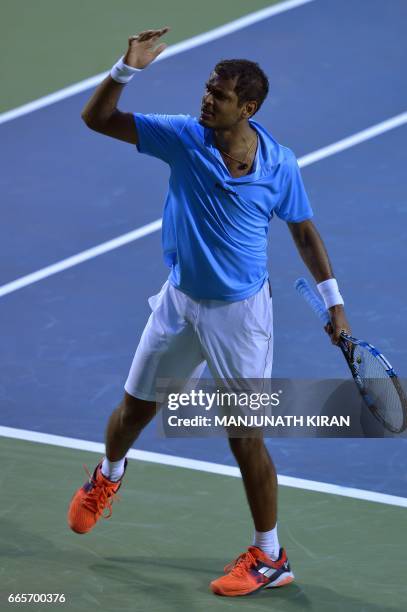 Indian player Ramkumar Ramanathan gestures after scoring a point during his singles match against Uzbekistan's Temur Ismailov at the Davis Cup Asia...