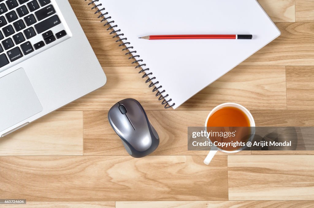 Overhead View Office Stuff On Desk Workplace with Laptop, Mouse, Green Tea, Notepad Retro Style