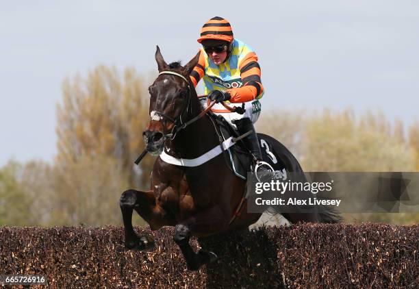 Might Bite ridden by Nico de Boinville clears the second to last on the way to victory during the Betway Mildmay Novices' Chase on Ladies Day at...