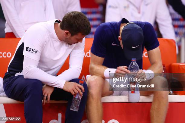 Leon Smith the Great Britain captain speaks with a dejected Kyle Edmund of Great Britain during the singles match against Lucas Pouille of France on...