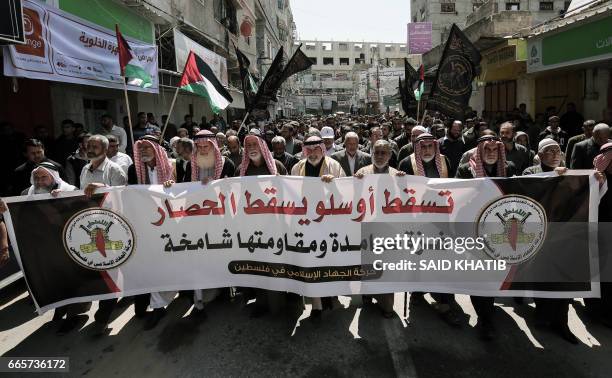 Palestinian supporters of Islamic Jihad Movement take part in a protest against Israel's siege on Gaza and decisions by the West Bank-based...