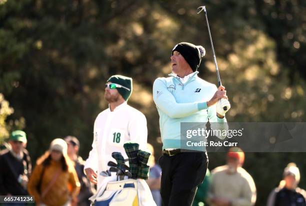 Matt Kuchar of the United States plays a shot on the first hole as caddie John Wood during the second round of the 2017 Masters Tournament at Augusta...