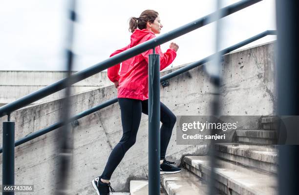 woman running up the stairs - metabolism stock pictures, royalty-free photos & images