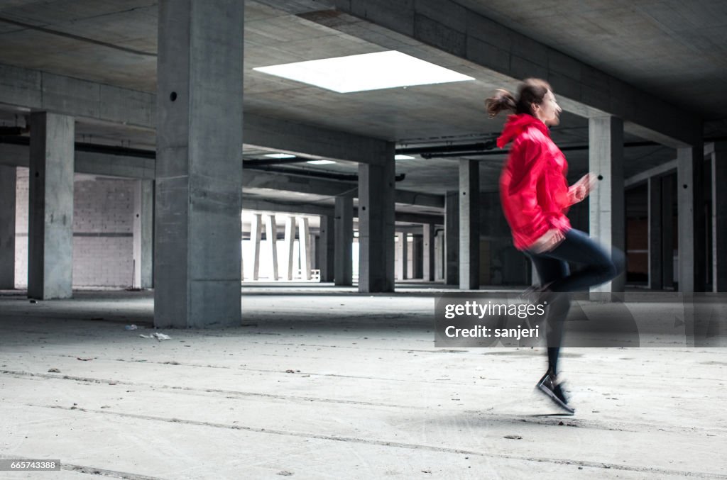 Young Female Athlete Skipping and Running Inside a Abandoned Building