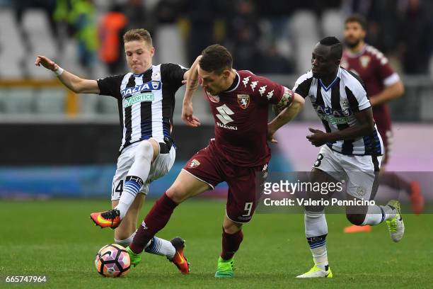 Andrea Belotti of FC Torino is challenged by Emmanuel Badu and Jakub Jankto of Udinese Calcio during the Serie A match between FC Torino and Udinese...