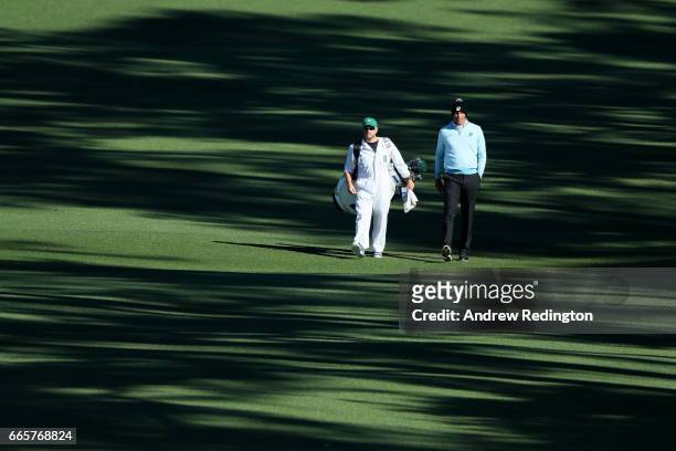 Matt Kuchar of the United States walks with caddie John Wood on the second hole during the second round of the 2017 Masters Tournament at Augusta...