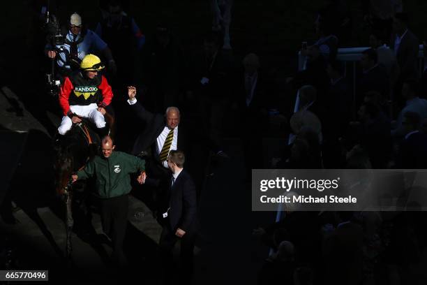 Ultragold ridden by Harry Cobden is led into the winers enclosure following victory during the Randox Health Topham Handicap Chase on Ladies Day at...