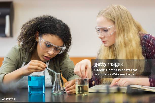 students conducting scientific experiment - 14 year old biracial girl curly hair stock pictures, royalty-free photos & images