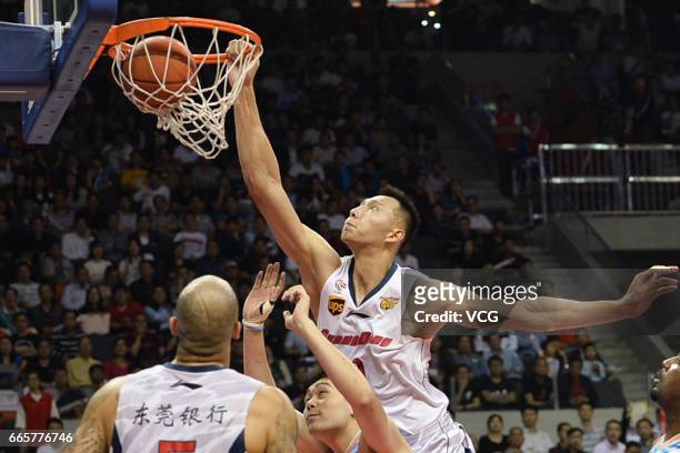 Yi Jianlian of Guangdong Southern Tigers dunks against Xinjiang Flying Tigers in Game Four of the 2017 CBA Finals at Dongguan Basketball Center on...