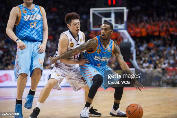 Darius Adams of Xinjiang Flying Tigers drives the ball against Guangdong Southern Tigers in Game Four of the 2017 CBA Finals at Dongguan Basketball...