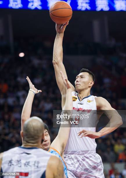 Yi Jianlian of Guangdong Southern Tigers shoots the ball against Xinjiang Flying Tigers in Game Four of the 2017 CBA Finals at Dongguan Basketball...