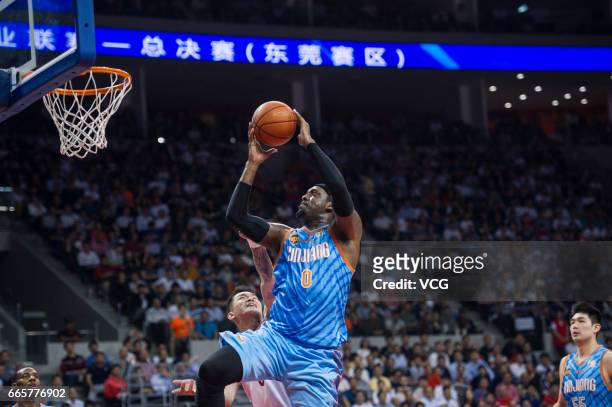 Andray Blatche of Xinjiang Flying Tigers shoots the ball against Guangdong Southern Tigers in Game Four of the 2017 CBA Finals at Dongguan Basketball...