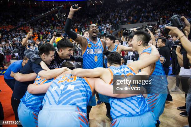 Players of Xinjiang Flying Tigers celebrate after defeating Guangdong Southern Tigers in Game Four of the 2017 CBA Finals at Dongguan Basketball...