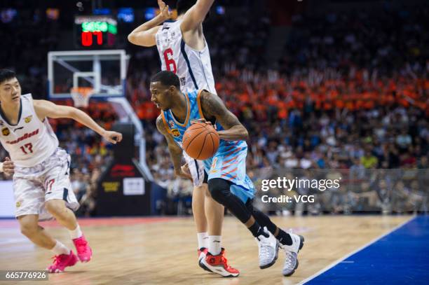 Darius Adams of Xinjiang Flying Tigers drives the ball against Guangdong Southern Tigers in Game Four of the 2017 CBA Finals at Dongguan Basketball...