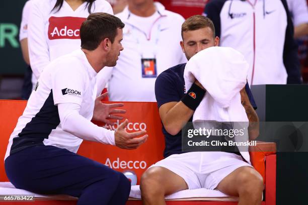 Leon Smith the Great Britain captain speaks with Daniel Evans of Great Britain during the singles match against Jeremy Chardy of France on day one of...