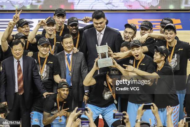 Players of Xinjiang Flying Tigers celebrate after defeating Guangdong Southern Tigers in Game Four of the 2017 CBA Finals at Dongguan Basketball...