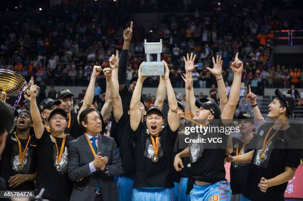 Players of Xinjiang Flying Tigers celebrate after defeating Guangdong Southern Tigers in Game Four of the 2017 CBA Finals at Dongguan Basketball...