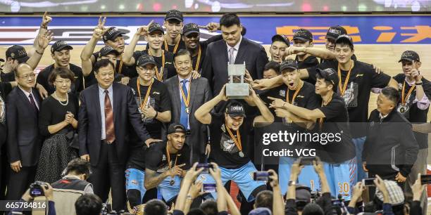 Players of Xinjiang Flying Tigers celebrate after defeating Guangdong Southern Tigers in Game Four of the 2017 CBA Finals at Dongguan Basketball...