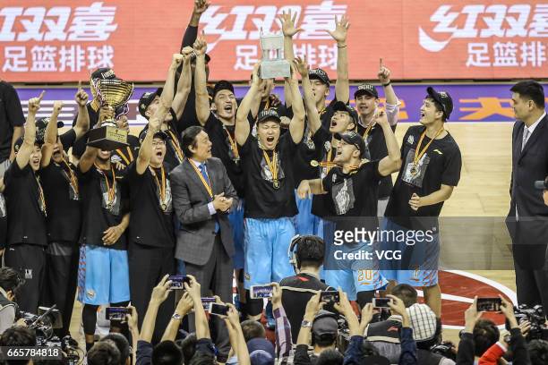 Players of Xinjiang Flying Tigers celebrate after defeating Guangdong Southern Tigers in Game Four of the 2017 CBA Finals at Dongguan Basketball...