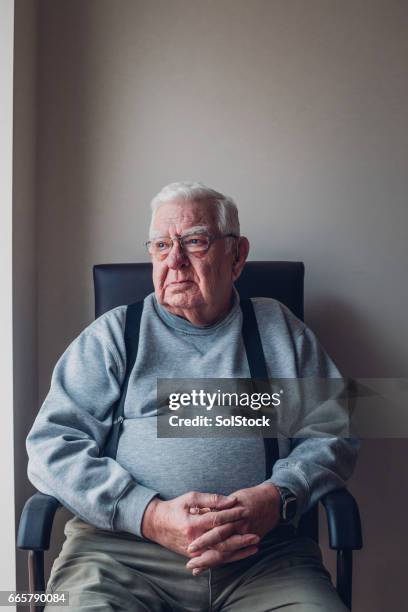 senior man sitting alone - fat man sitting stock pictures, royalty-free photos & images