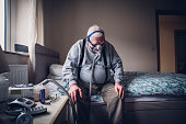 Elderly Man Using a Medical Breathing Apparatus