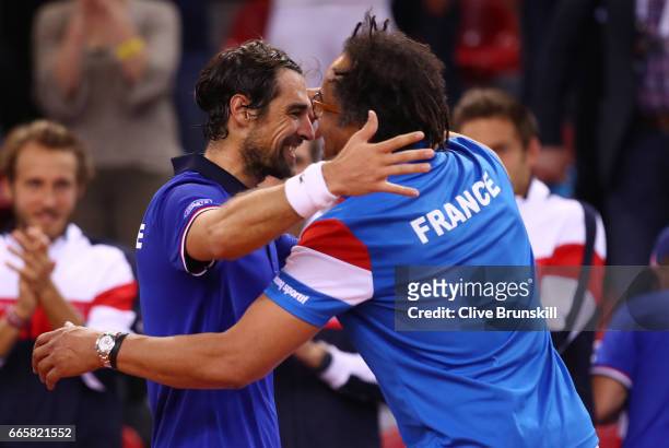 Jeremy Chardy of France celebrates with Yannick Noah the France captain following his victory during the singles match against Daniel Evans of Great...