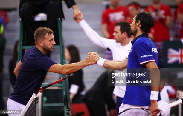 Daniel Evans of Great Britain shakes hands with Jeremy Chardy of France following his defeat during the singles match on day one of the Davis Cup...