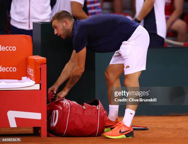 Daniel Evans of Great Britain leaves the court following his defeat during the singles match against Jeremy Chardy of France on day one of the Davis...