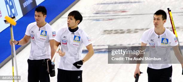 Tetsuro Shimizu, Yusuke Morozumi and Tsuyoshi Yamaguchi of Japan are seen in the round-robin match against Canada during day five of the World Men's...