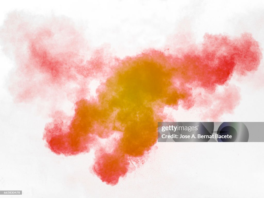 Explosion of a cloud of powder of particles of  colors red and orange on a white background