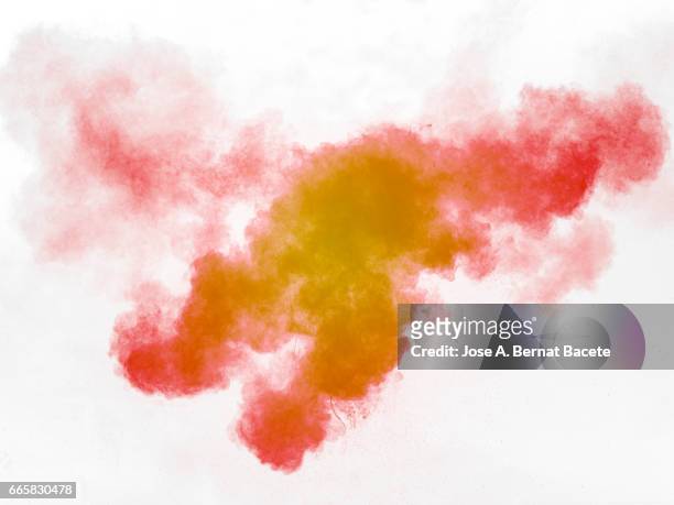 explosion of a cloud of powder of particles of  colors red and orange on a white background - naturaleza muerta imagens e fotografias de stock