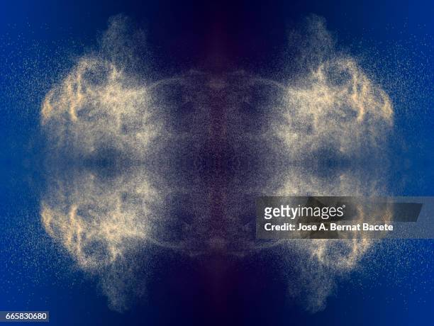 explosion of water drops of  colors gray and brown, floating in the air  on a blue background - etéreo stockfoto's en -beelden