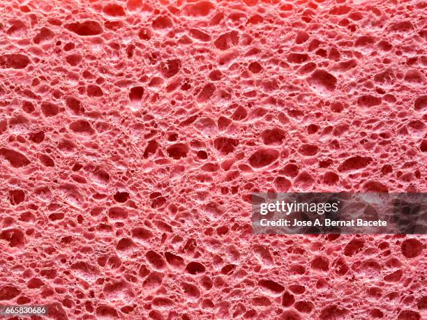 full frame of coarse and wavy textures of colored foam, pink background - agujero stock-fotos und bilder