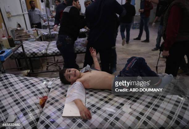 Syrian child receives treatment at a makeshift clinic following reported air strikes by government forces in the rebel-held town of Douma, on the...