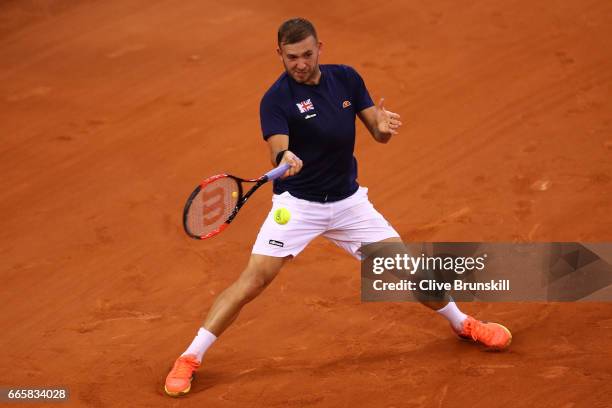 Daniel Evans of Great Britain hits a forehand during the singles match against Jeremy Chardy of France on day one of the Davis Cup World Group...