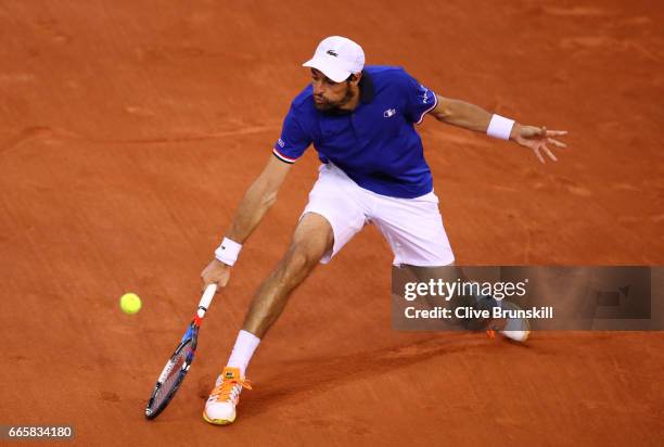 Jeremy Chardy of France volleys during the singles match against Daniel Evans of Great Britain on day one of the Davis Cup World Group Quarter-Final...