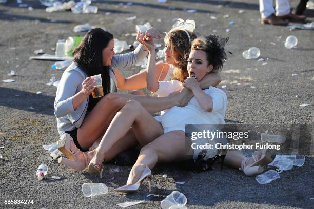 Racegoers enjoy the party atmosphere of Ladies Day at the Randox Health Grand National Festival at Aintree Racecourse on April 6, 2017 in Liverpool,...