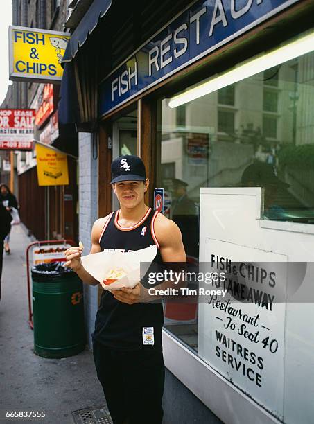 Marky Mark, singer and rapper of the Funky Bunch, posing outside a fish and chip shop in London, circa 1991.