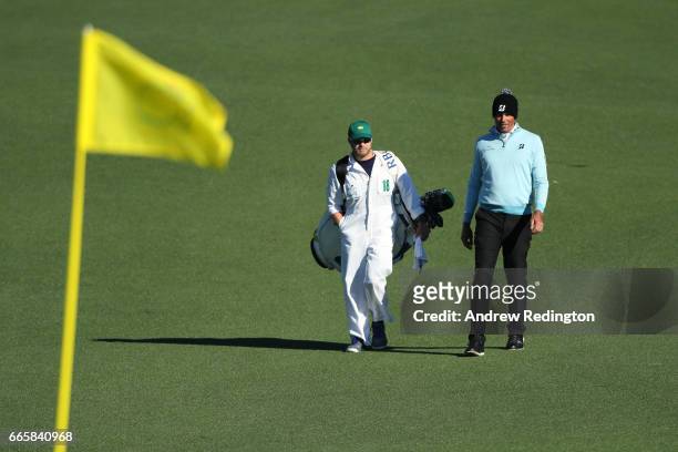 Matt Kuchar of the United States walks the second hole with caddie John Wood during the second round of the 2017 Masters Tournament at Augusta...