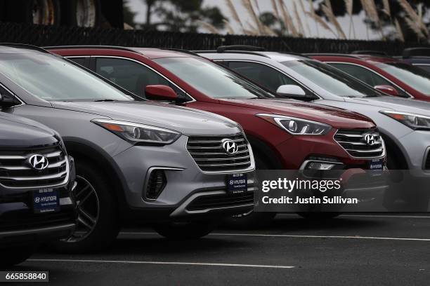 Brand new Hyundai Santa Fe SUVs are displayed at a Hyundai dealership on April 7, 2017 in Colma, California. South Korean automakers Kia and Hyundai...