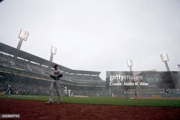 The Atlanta Braves come off the field in the fourth inning during a snow squall against the Pittsburgh Pirates on Opening Day at PNC Park on April 7,...