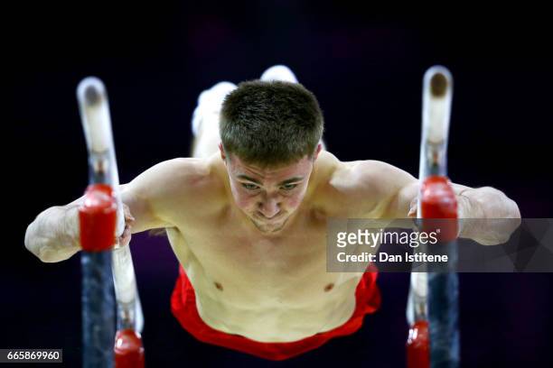Sam Oldham of Great Britain takes part in a practice session on the parallel bars during previews to the iPro Sport World Cup of Gymnastics at The O2...