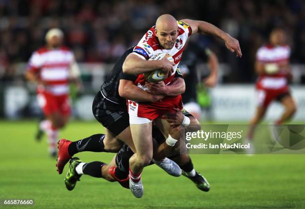 Charlie Sharples of Gloucester Rugby is tackled by Michael Young of Newcastle Falcons during the Aviva Premiership match between Newcastle Falcons...