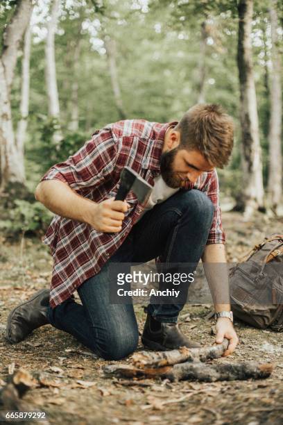 hiker chopping wood for campfire - chopping stock pictures, royalty-free photos & images