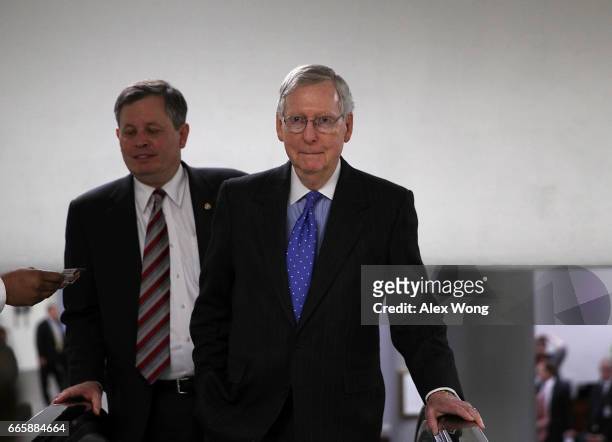 Senate Majority Leader Sen. Mitch McConnell leaves with Sen. Steve Daines after a closed briefing on the airstrikes against Syria by Chairman of the...