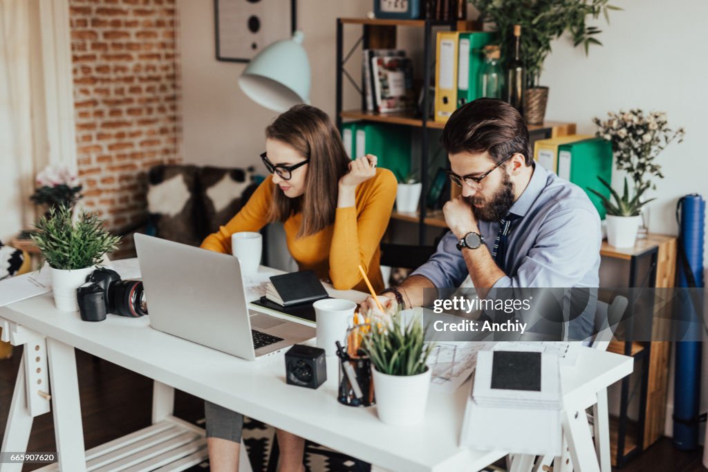 Two young businessman working together on a project