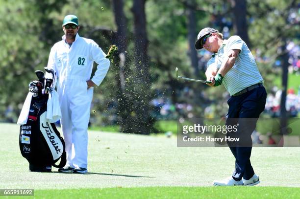 Charley Hoffman of the United States plays a shot on the 17th hole as caddie Brett Waldman during the second round of the 2017 Masters Tournament at...