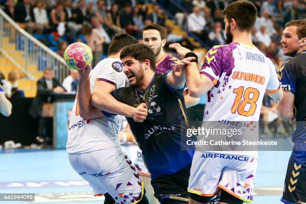 Benjamin Afgour of Dunkerque Handball is trying to shoot the ball against Nicolas Tournat and Eduardo Gurbindo of HBC Nantes during the semi-final...