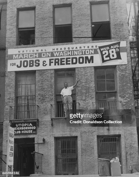 Administrative Committee Chairman Cleveland Robinson standing on second floor balcony of the National Headquarters of the March on Washington in...