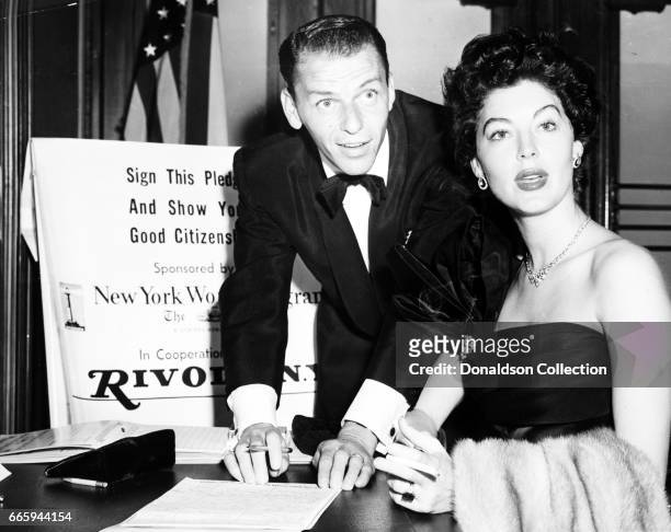 Entertainers Frank Sinatra and Ava Gardner sign a pledge as good ciitzens on September 19, 1952 in New York, New york.